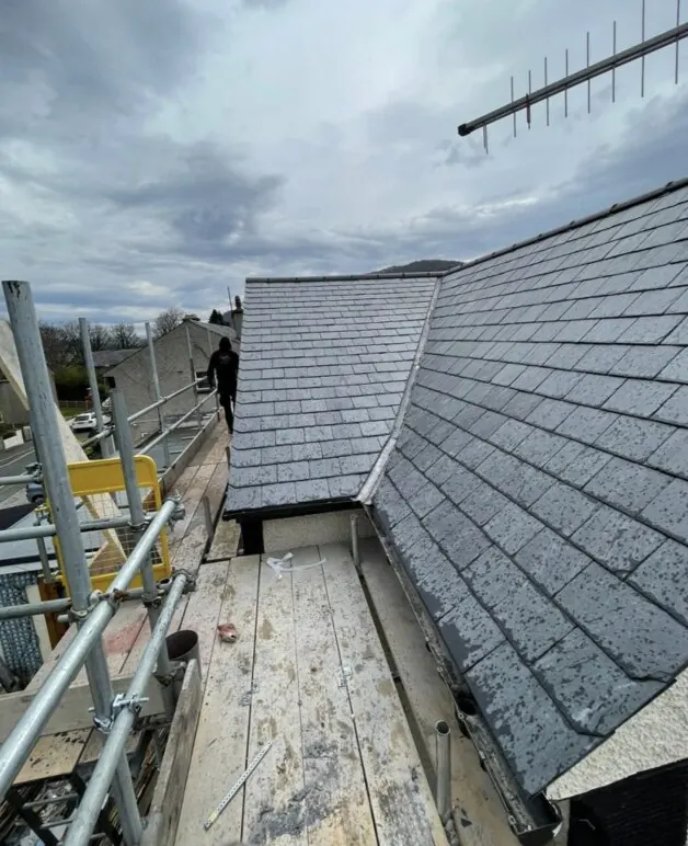 Freshly laid slate roof against clear blue sky