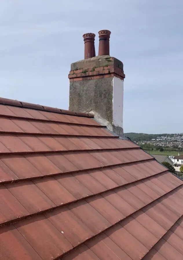 Roofer applying torch-on felt to a flat roof