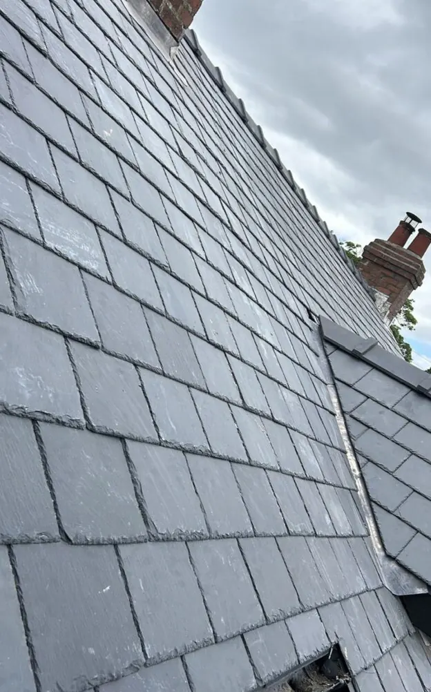 Newly finished slate roof with lead ridge detail